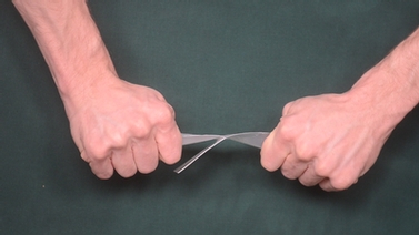 hands pulling apart a piece of plastic