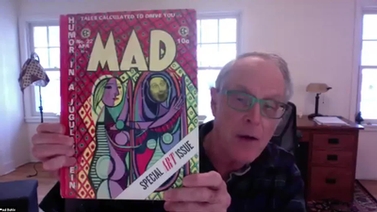 panelist holds up an issue of MAD Magazine