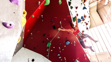 Women hangs from new Lindseth climbing wall