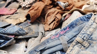 Clothes lie in the rubble at Rana Plaza
