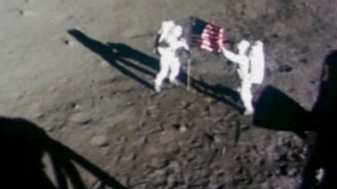 Apollo 11 astronauts unfurl the American flag on the moon