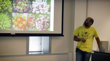 Anurag Agrawal looks at the projector screen showing different flowers