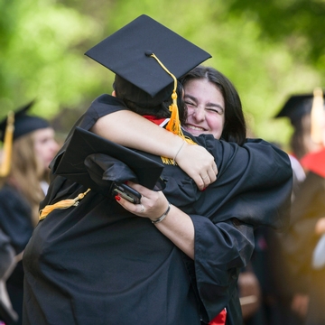 Students hugging at graduation 