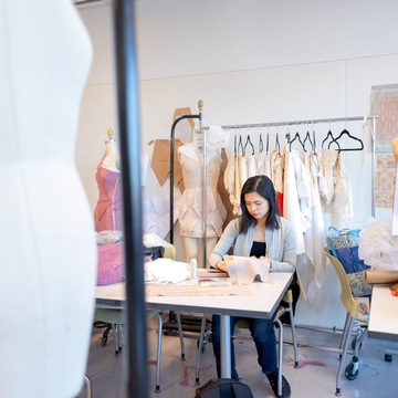 Angela Lan ’24 works on her line for the Cornell Fashion Collective Spring Runway Show in the Human Ecology building design studios. 