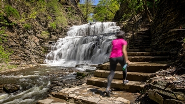 woman walks up the steps in one of Ithaca's gorges