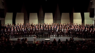 Members of the Glee Club on stage at Bailey Hall