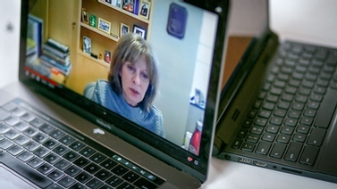 A laptop screen displaying the zoom meeting.