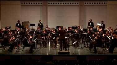 The wind symphony performing onstage.