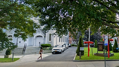 The sidewalk and street in front of the Cooperative Extension building in Queens.