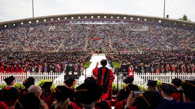 Wide shot of the Cornell graduation at Schoellkopf Stadium. 