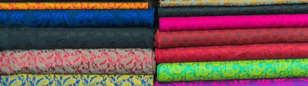 stacks of multi-colored fabrics, folded neatly